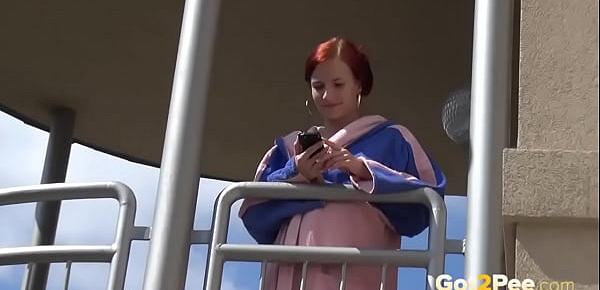  Redhead pees over her balcony in the city